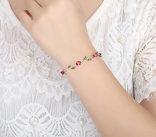 The bracelet is made of entwined red crystals and green leaf-shaped crystals