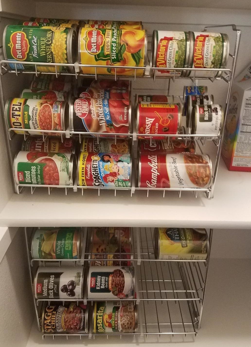 Reviewer&#x27;s pantry with two of the metal wire racks, which are full of cans