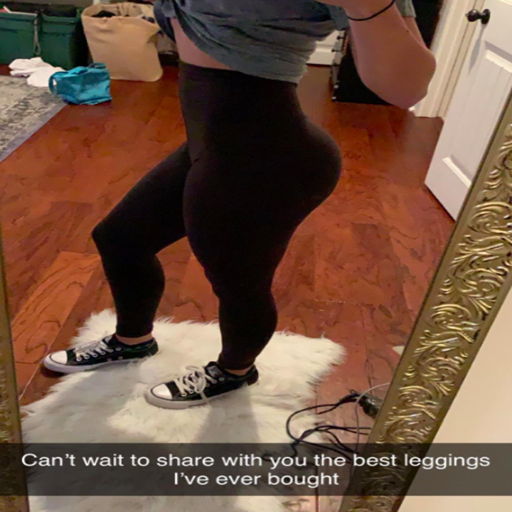 A customer review photo of them wearing the tights with the text, "Can't wait to share with you the best leggings I've ever bought."