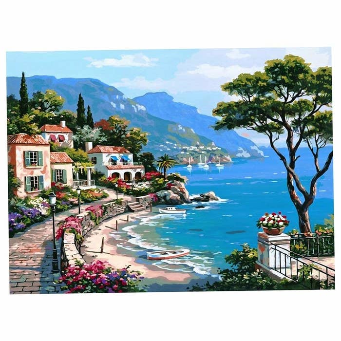 A seaside painting with houses near it