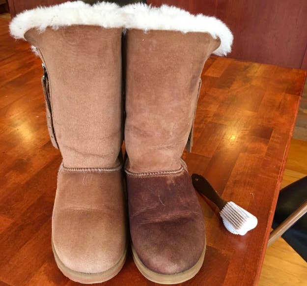 Reviewer photo of on the left, an ugg boot looking clean after using the brush, and on the right, the other boot in the pair still looking dirty before using the brush