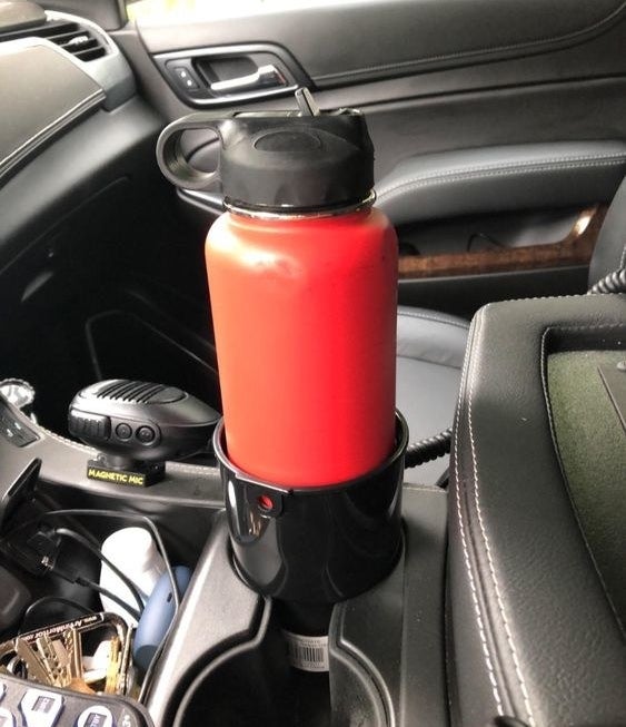 A reviewer&#x27;s large water bottle sitting in the cup holder