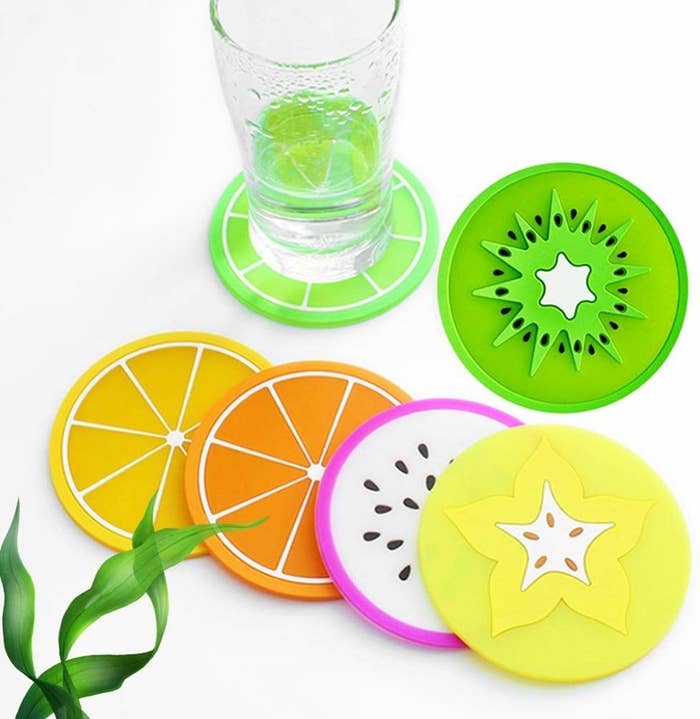 A glass sitting on one of the fruit coasters, surrounded by others