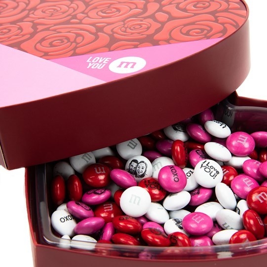 M&amp;amp;M candies in pink, white, and red with messages and print of a couples&#x27; faces on the backs 