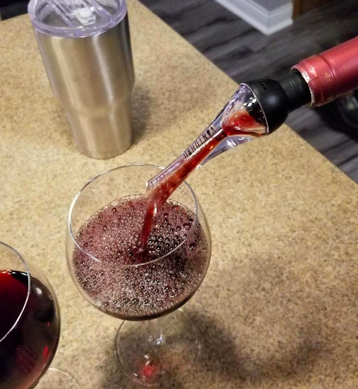 reviewer pouring wine with the aerator