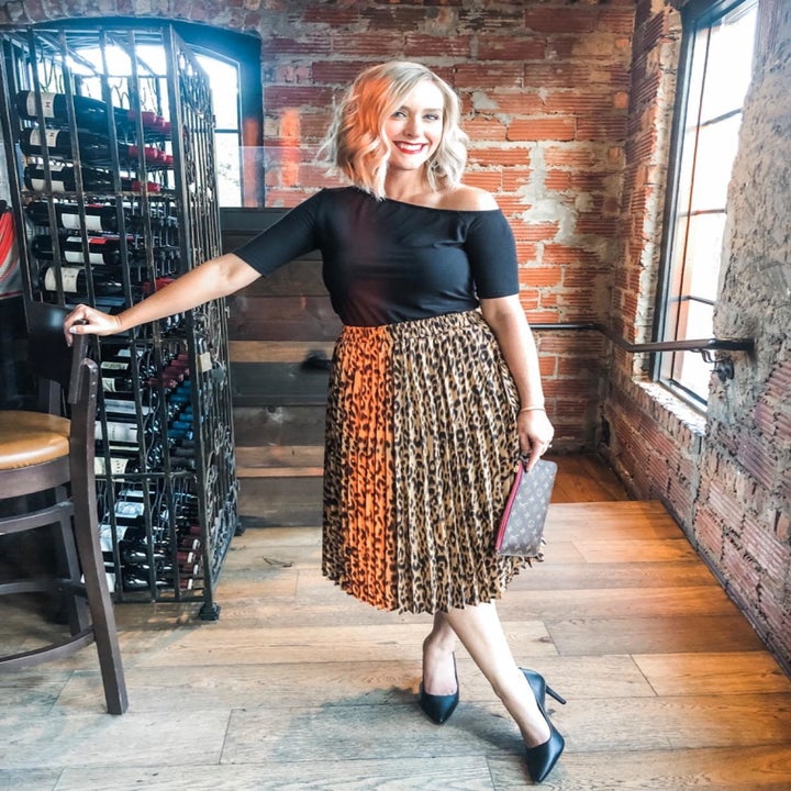 Reviewer wearing leopard print skirt