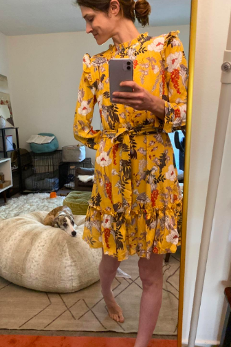 reviewer wearing the yellow floral print with ruffles on shoulders