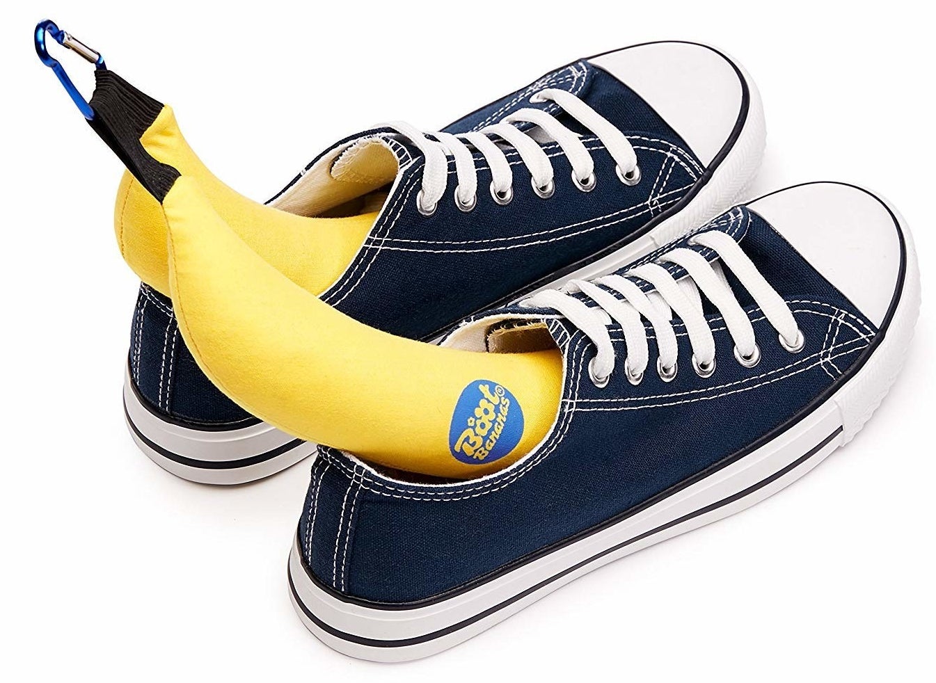 The banana-shaped deodorizers half inserted into a pair of tennis shoes