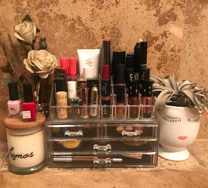 The organizer holding a variety of beauty products