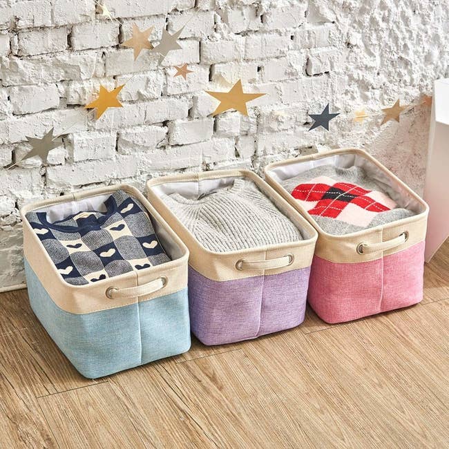 three collapsable storage bins in light blue purple and pink