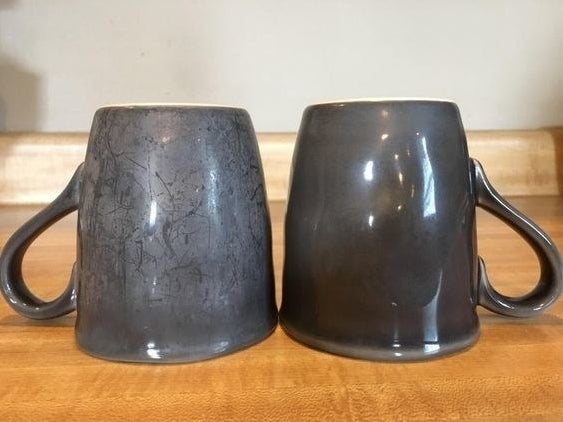 reviewer photo showing one mug that hadn&#x27;t been washed with the Finish booster, and another that has, showing the latter much cleaner and no evidence of hard water 