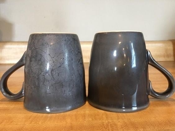 reviewer photo showing one mug that hadn&#x27;t been washed with the Finish booster, and another that has, showing the latter much cleaner and no evidence of hard water 