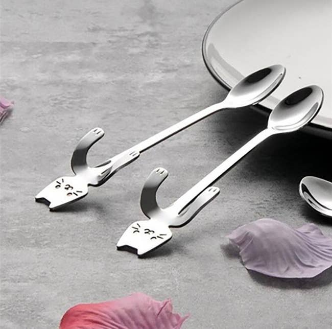 spoons with car shaped handles with arms that hook over side of mug 