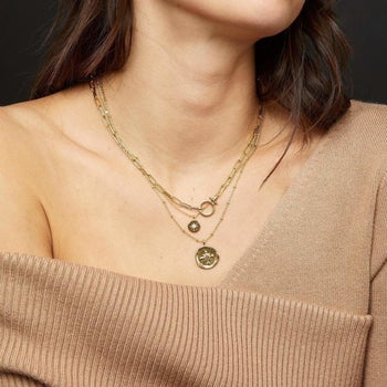 model wearing the necklace, showing that the length hits in the middle of the chest