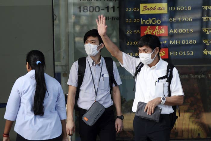 Travellers wearing face masks