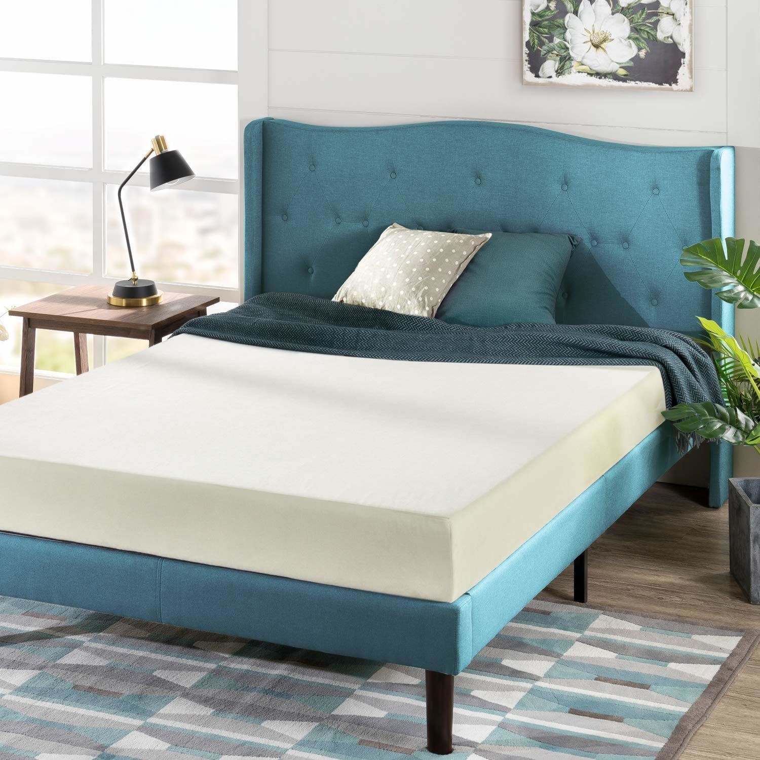 A thick foam mattress on a bed with pillows