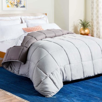 gray fluffy reversible comforter on a bed