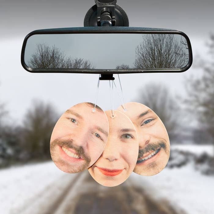 air freshener featuring someone&#x27;s face hanging on car mirror
