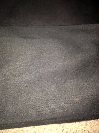 Reviewer photo of the same couch that's now free of all hair after using the vacuum