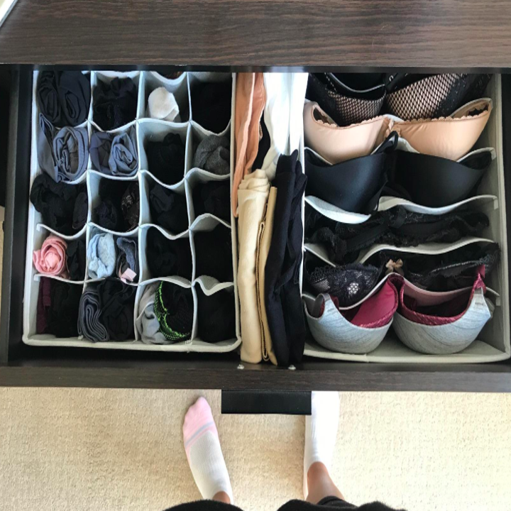 A customer review photo of their bras and socks neatly organized in a drawer in one of the removable inserts