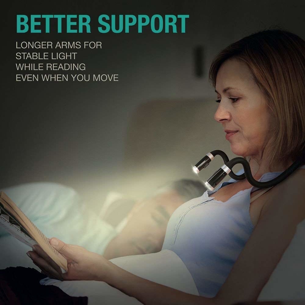 A person reading in bed with the light around their neck.