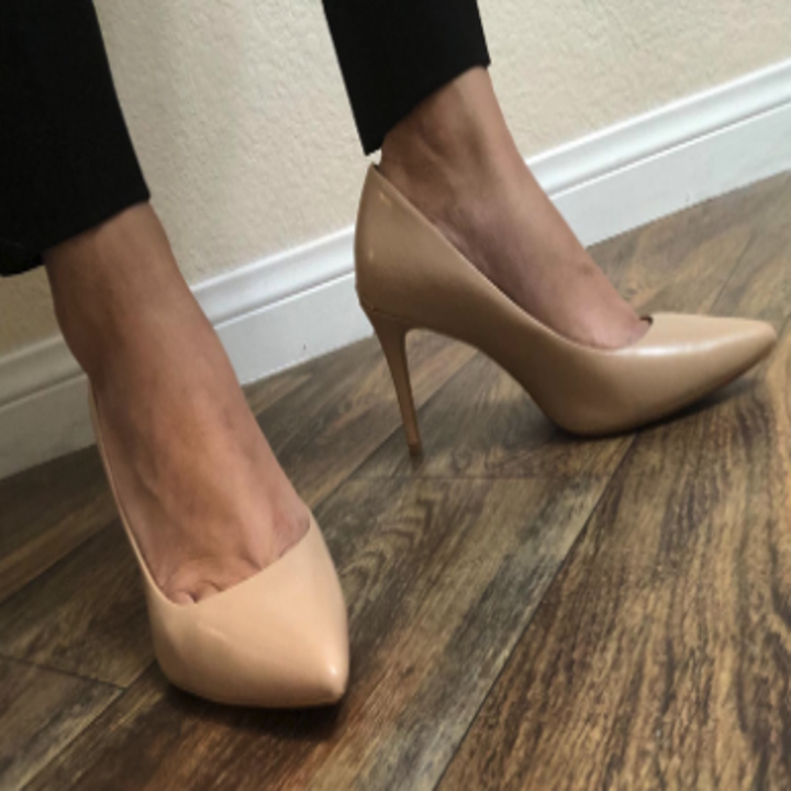 a model wearing the heels in patent nude with a pointed toe