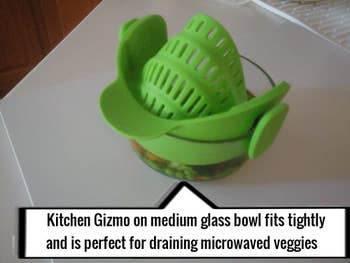 a reviewer's photo of the strainer clipped to a small glass bowl to drain microwaved veggies