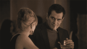 a gif of ty burrell from modern family saying i&#x27;m pretty smooth all over while seductively smoking a cigarette