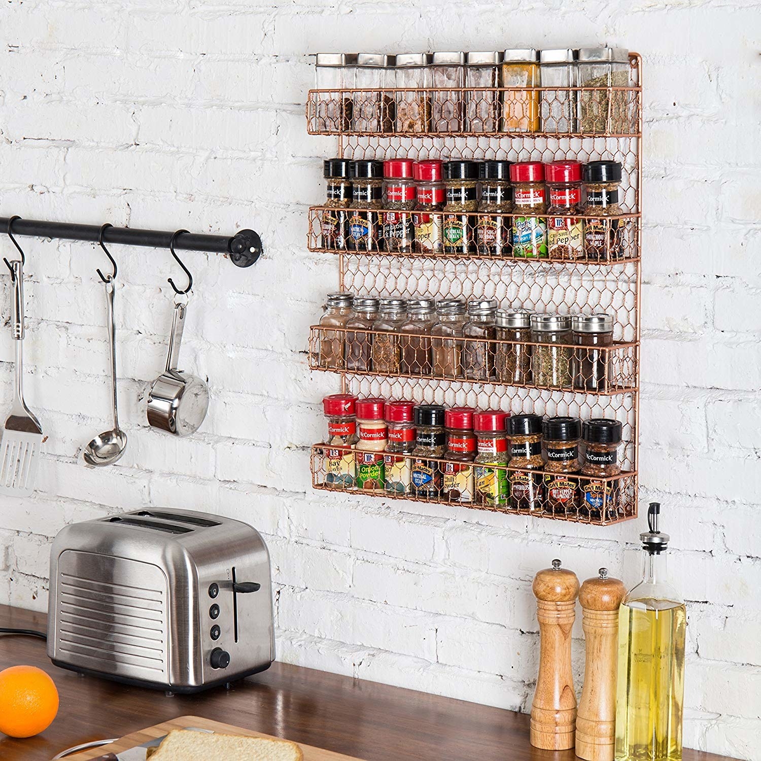 A wire spice rack with four shallow shelves that give enough room to store up to around 36 spices 