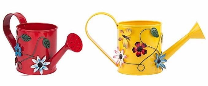 Red and yellow watering cans with flowers on them.