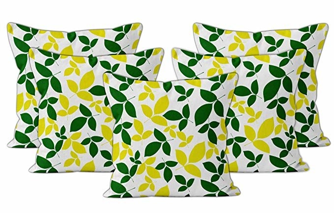 White cushion covers with a green and yellow leaf print design.