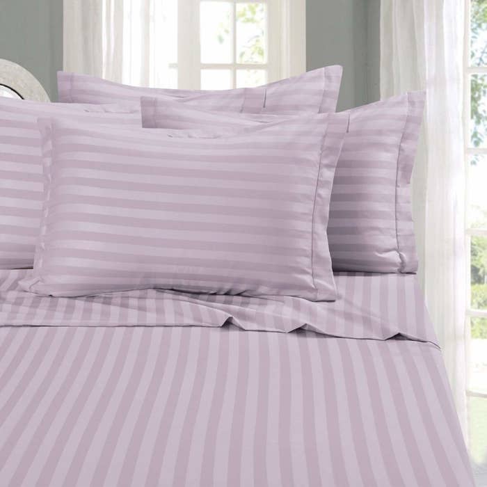 Light purple striped sheets on bed
