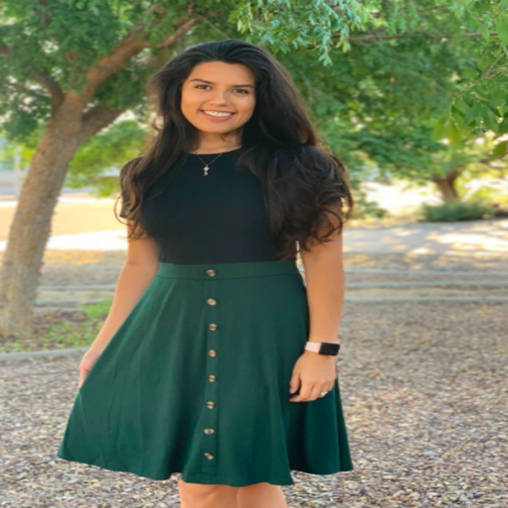 a reviewer wearing the dress in black and green