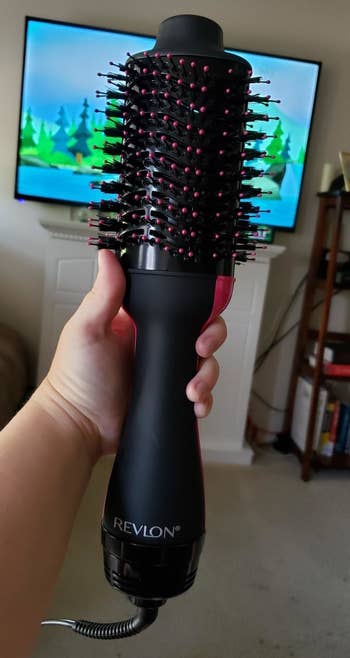 Reviewer holding the hair drying brush 