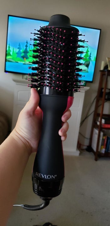 Reviewer holding the hair drying brush 