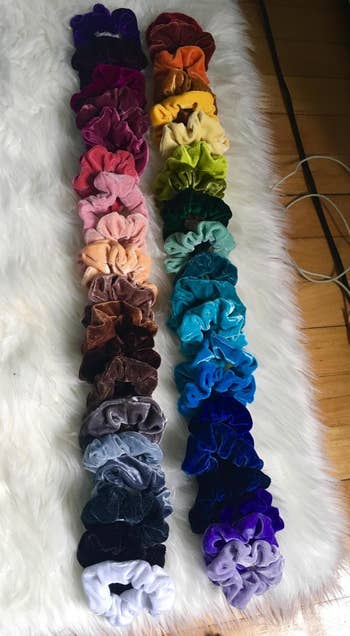 All 40 scrunchies in different colors of the rainbow laid on out on the floor 