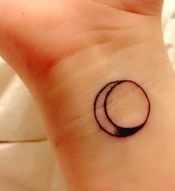 Sun/moon combo tattoo on someone&#x27;s inner wrist