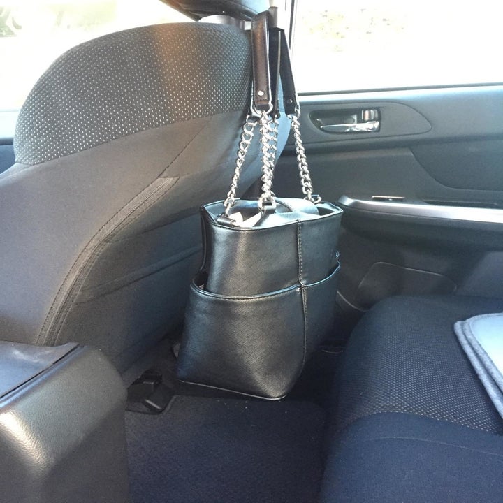 reviewer's photo of the hook holding their large purse