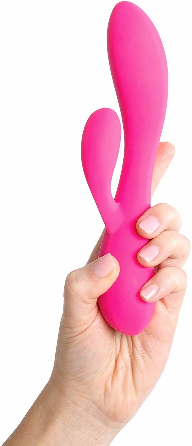 Hand holding the pink rabbit-style toy