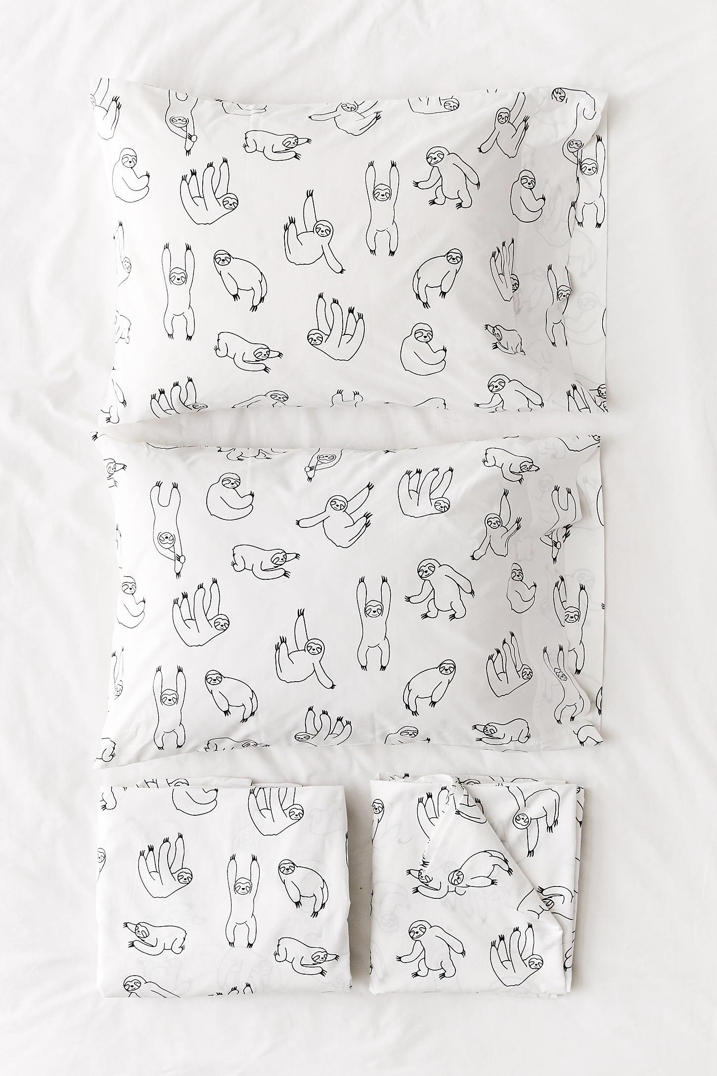 sheets with illustrated sloths on them