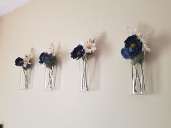 reviewer image of multiple vases with flowers on the wall 