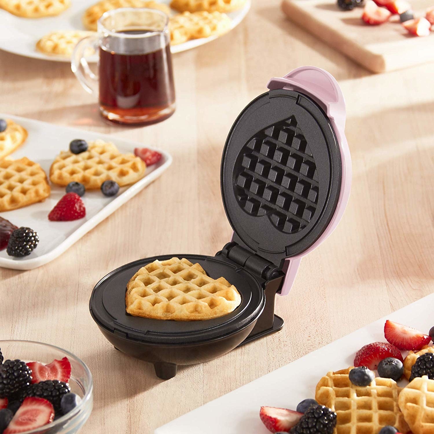 the heart shaped waffle maker with a waffle in it