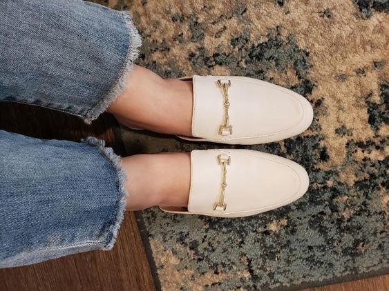 reviewer wearing mules in white 
