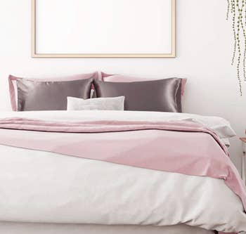 gray satin pillowcases on a bed