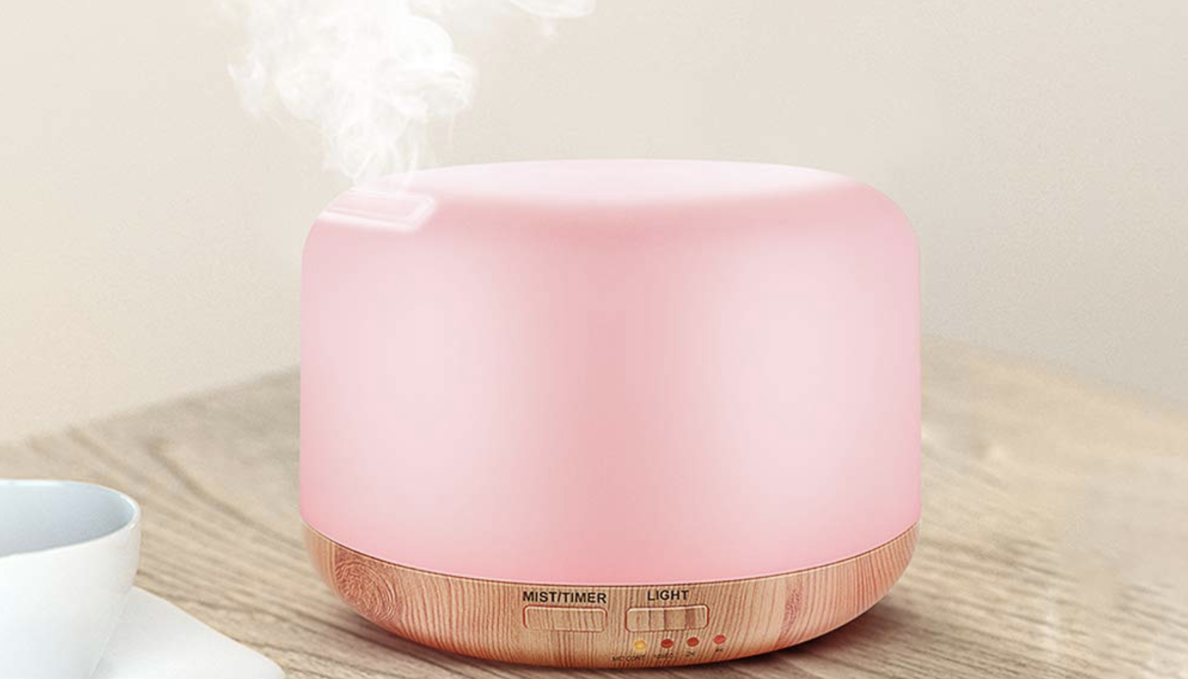 pink oil diffuser on a desk 