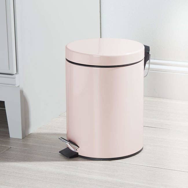 pale pink small trashcan with foot pedal lid 