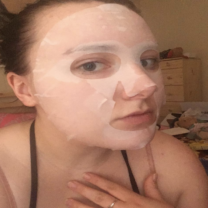 Reviewer wears one of the facial sheet masks