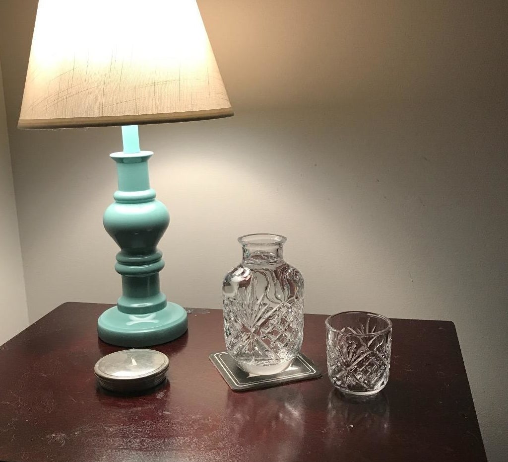 reviewer image of crystal carafe and cup set  on a bedside table 