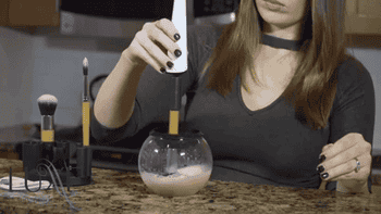 gif of someone cleaning a brush in the bowl