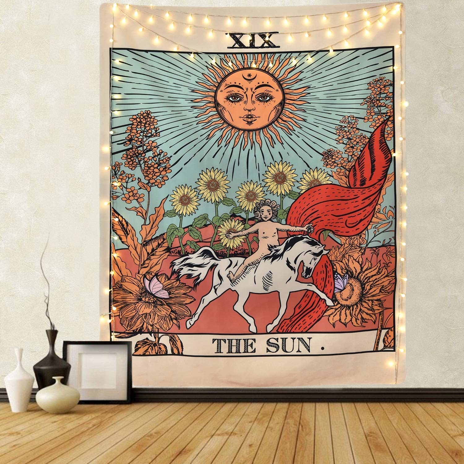 tarot card of the sun tapestry hung on wall